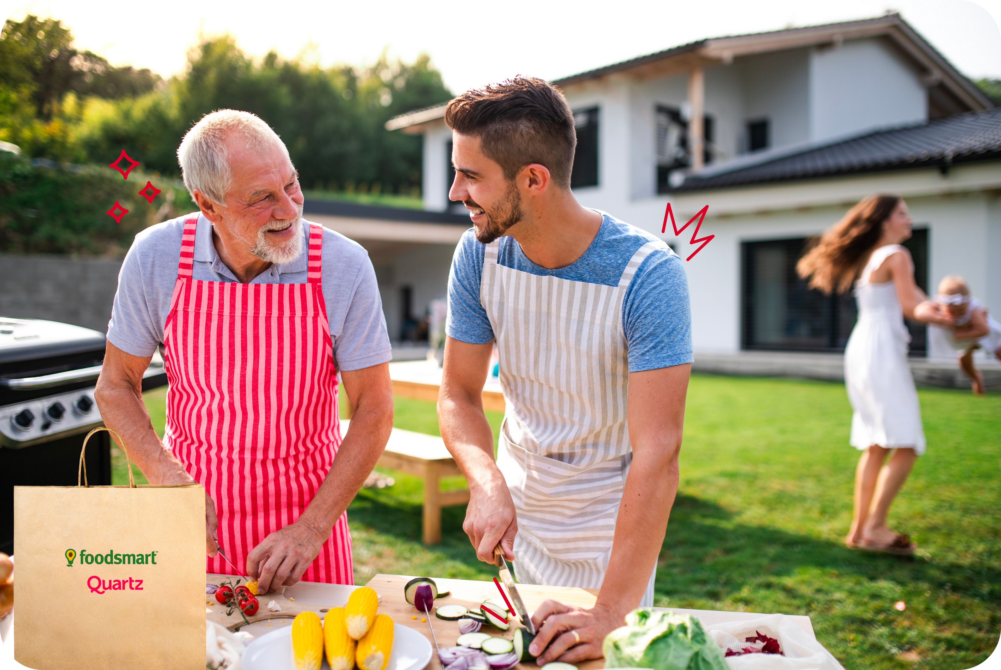 Photo of two men happily chopping vegetables for an outdoor meal