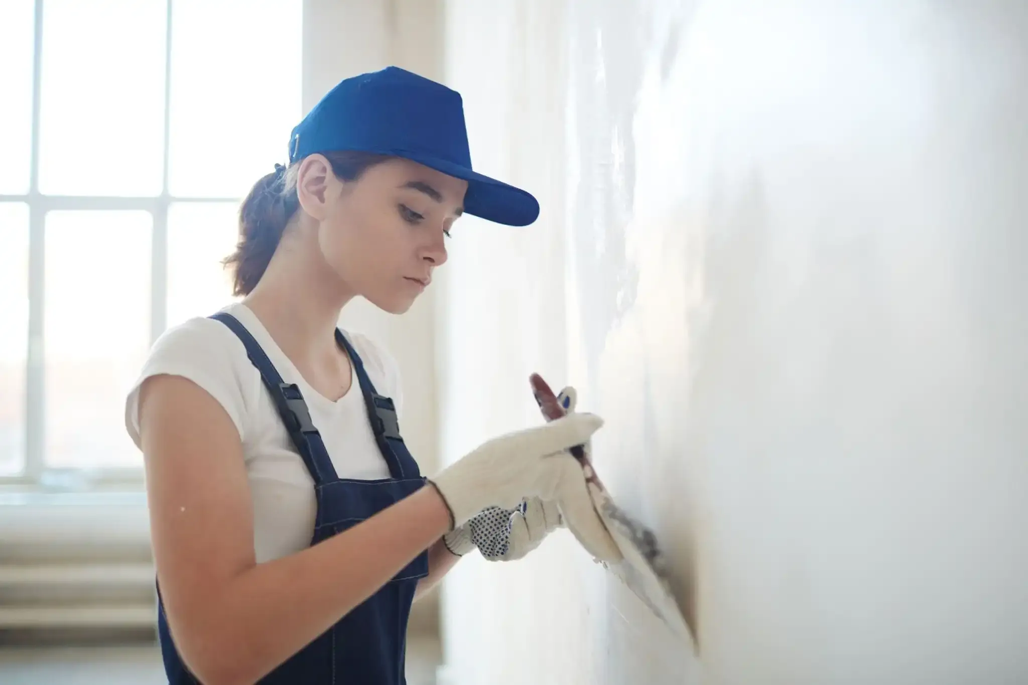 Woman working on wall