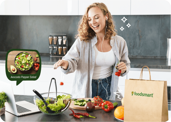 Photo of a happy, fit woman preparing a colorful meal from an online recipe