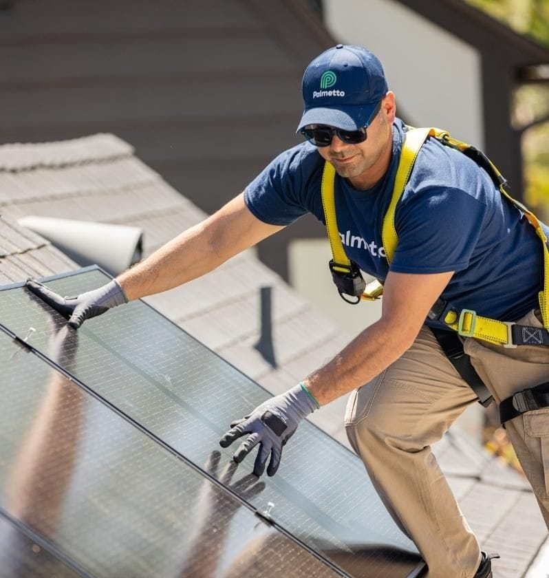 A Palmetto Build Partner installs solar panels on a roof