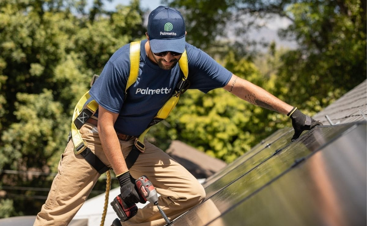 A Palmetto Build Partner installing solar panels on a roof