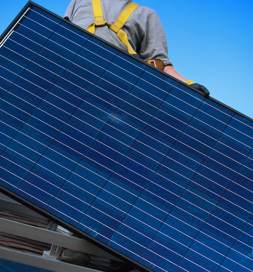Image of a solar panel being installed on a residential roof.