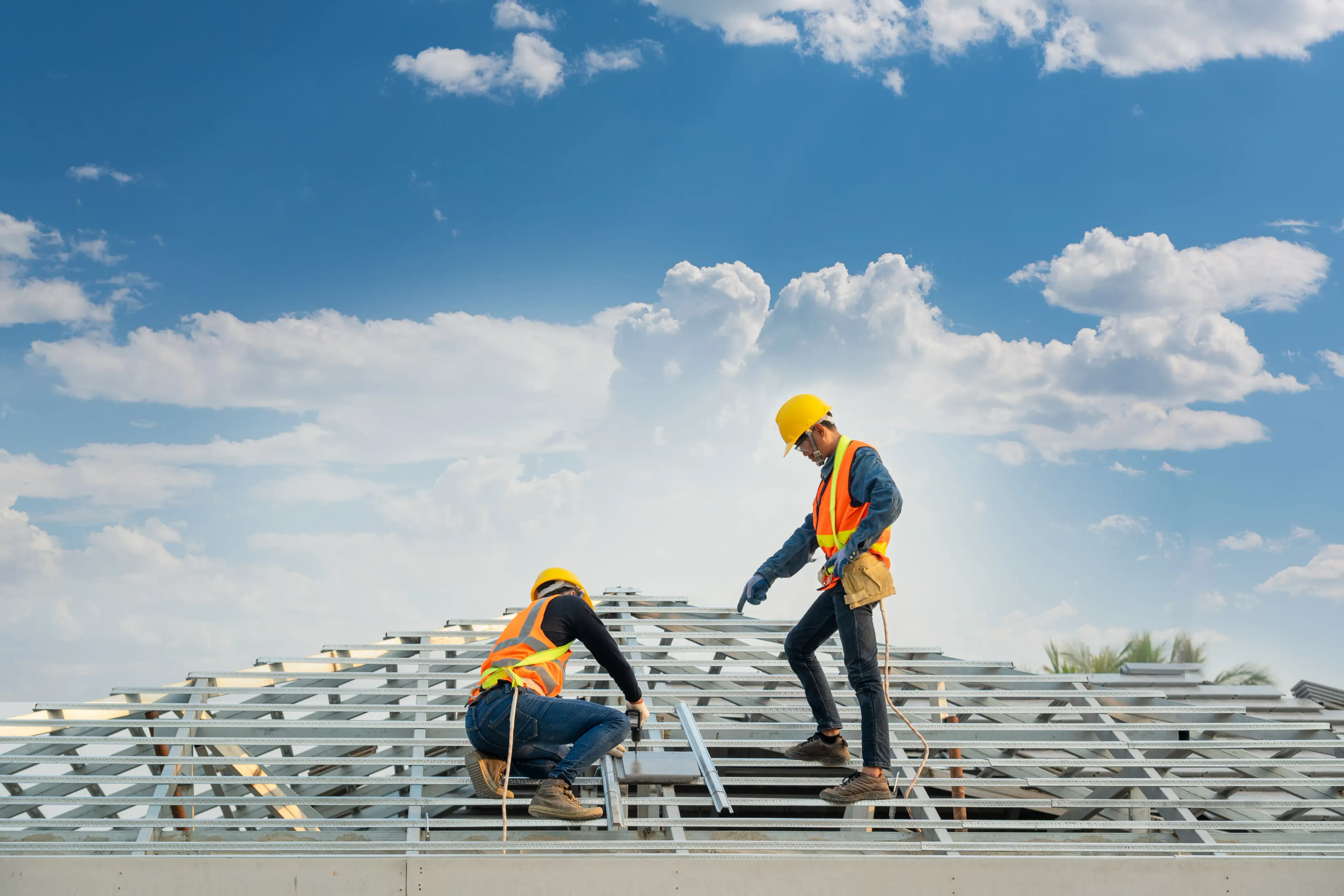 Two construction workers on roof