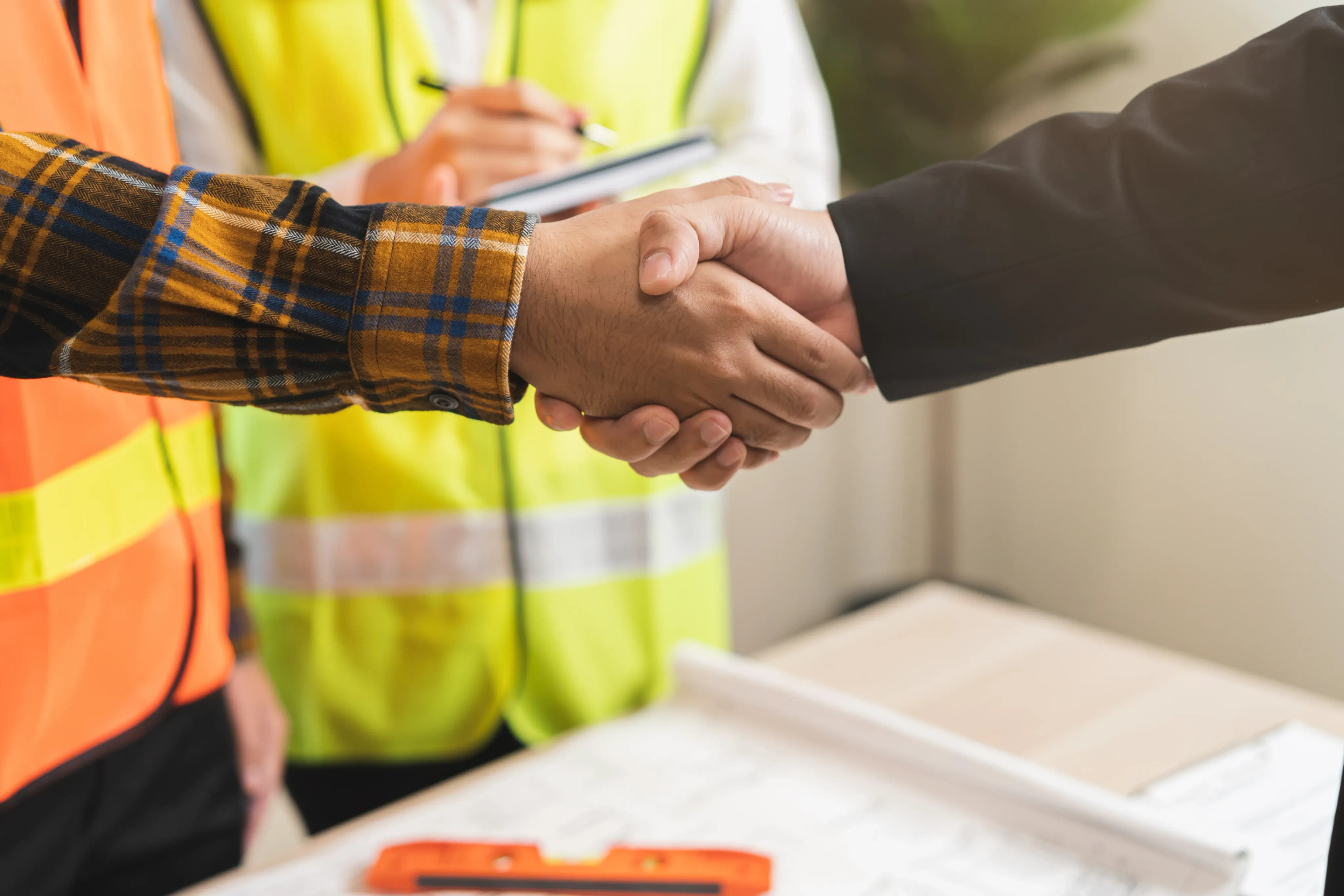 Construction worker and LBM supplier shaking hands