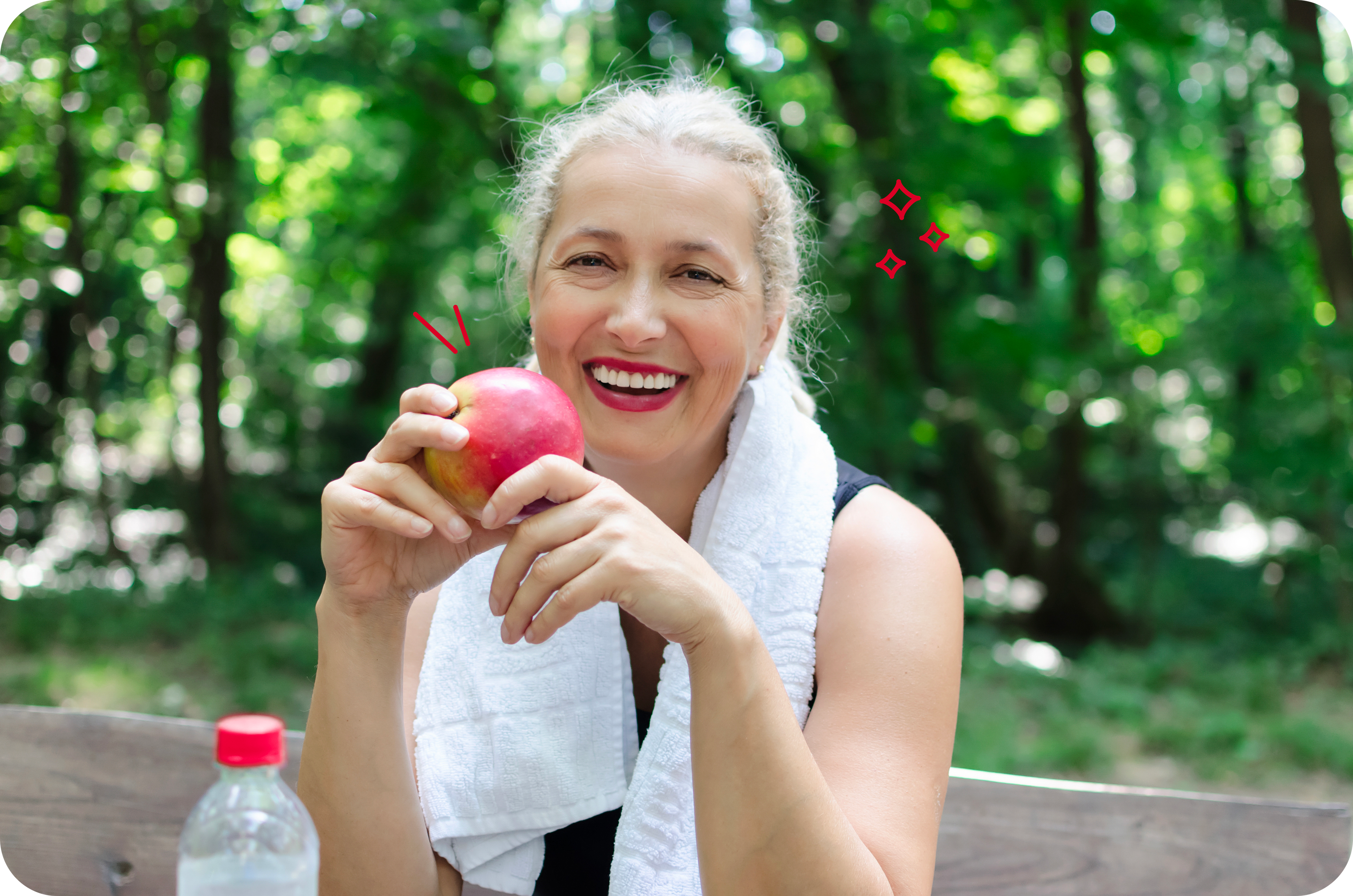 Photo of a smiling woman eating a healthy snack after exercise