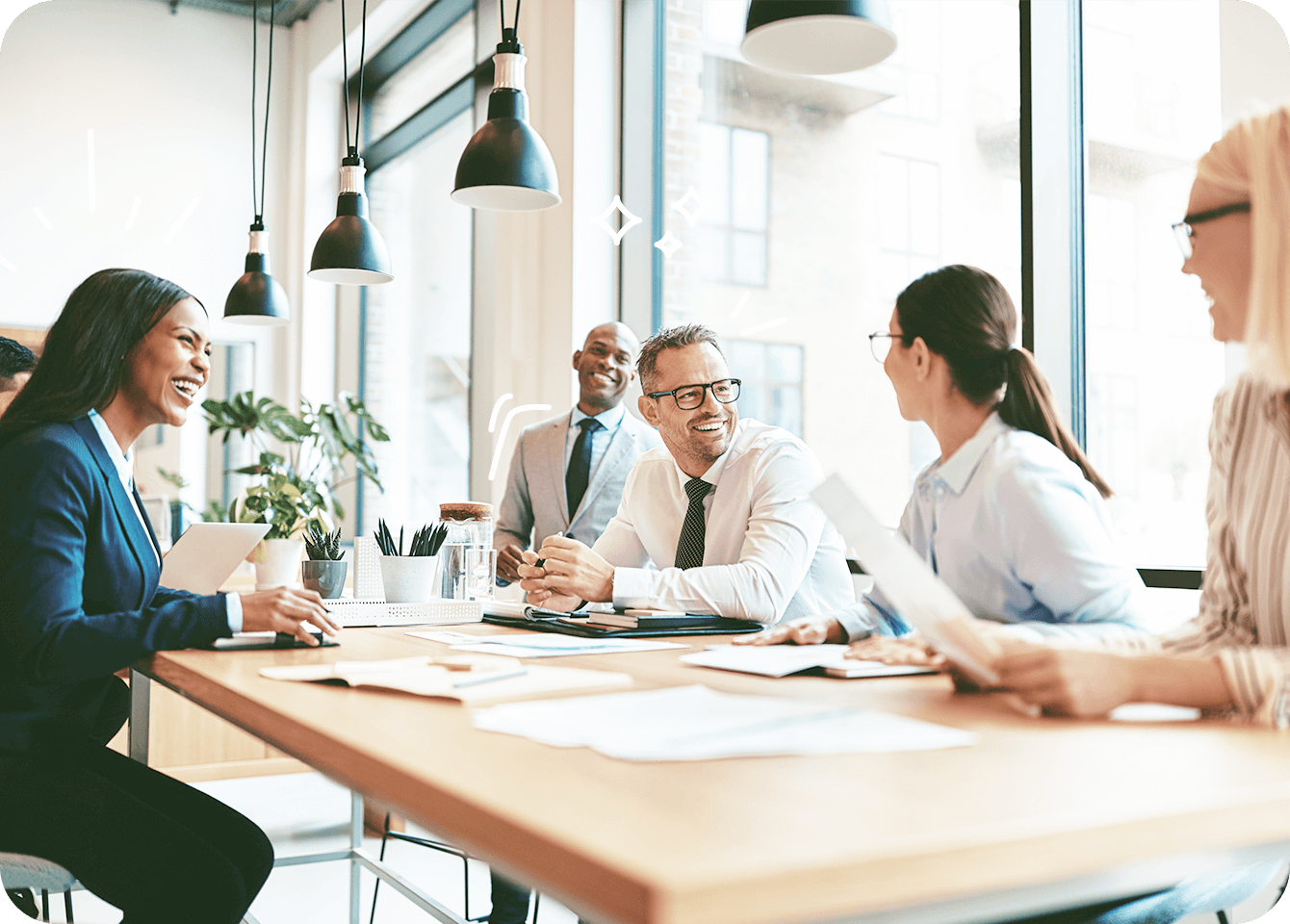 Photo of cheerful, healthy employees at a conference table