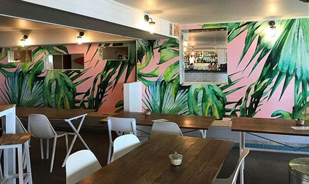 pink jungle wall mural in a beach cafe in australia
