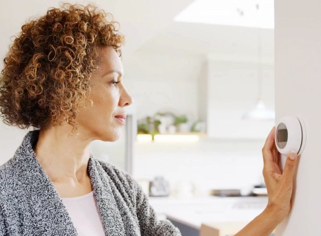 Vide screenshot of a woman changing her thermostat