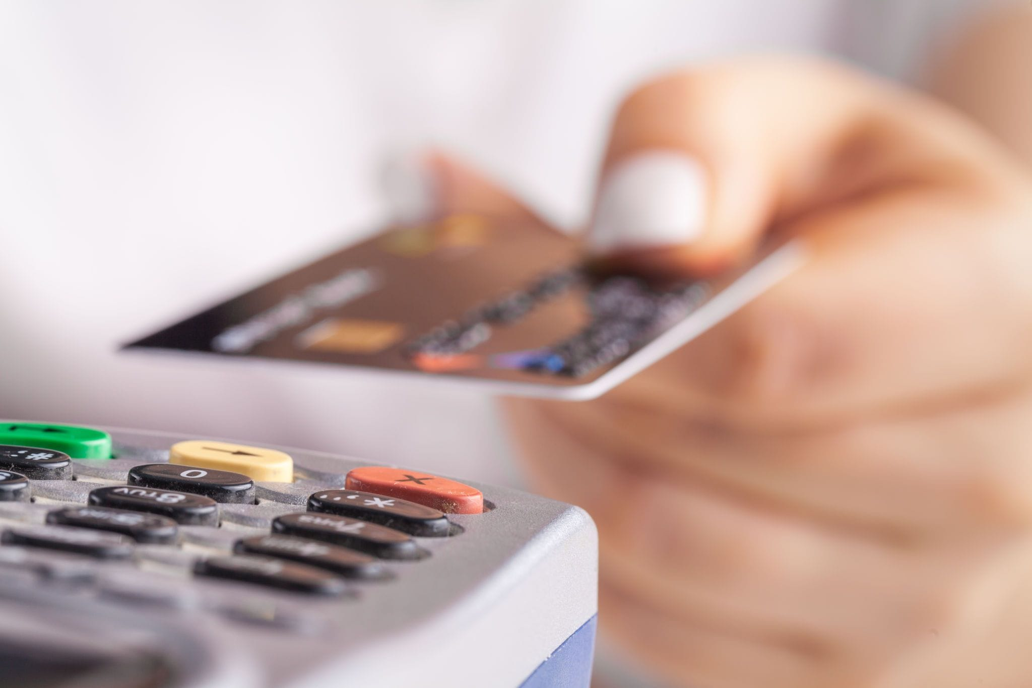 Credit card being held up to reader