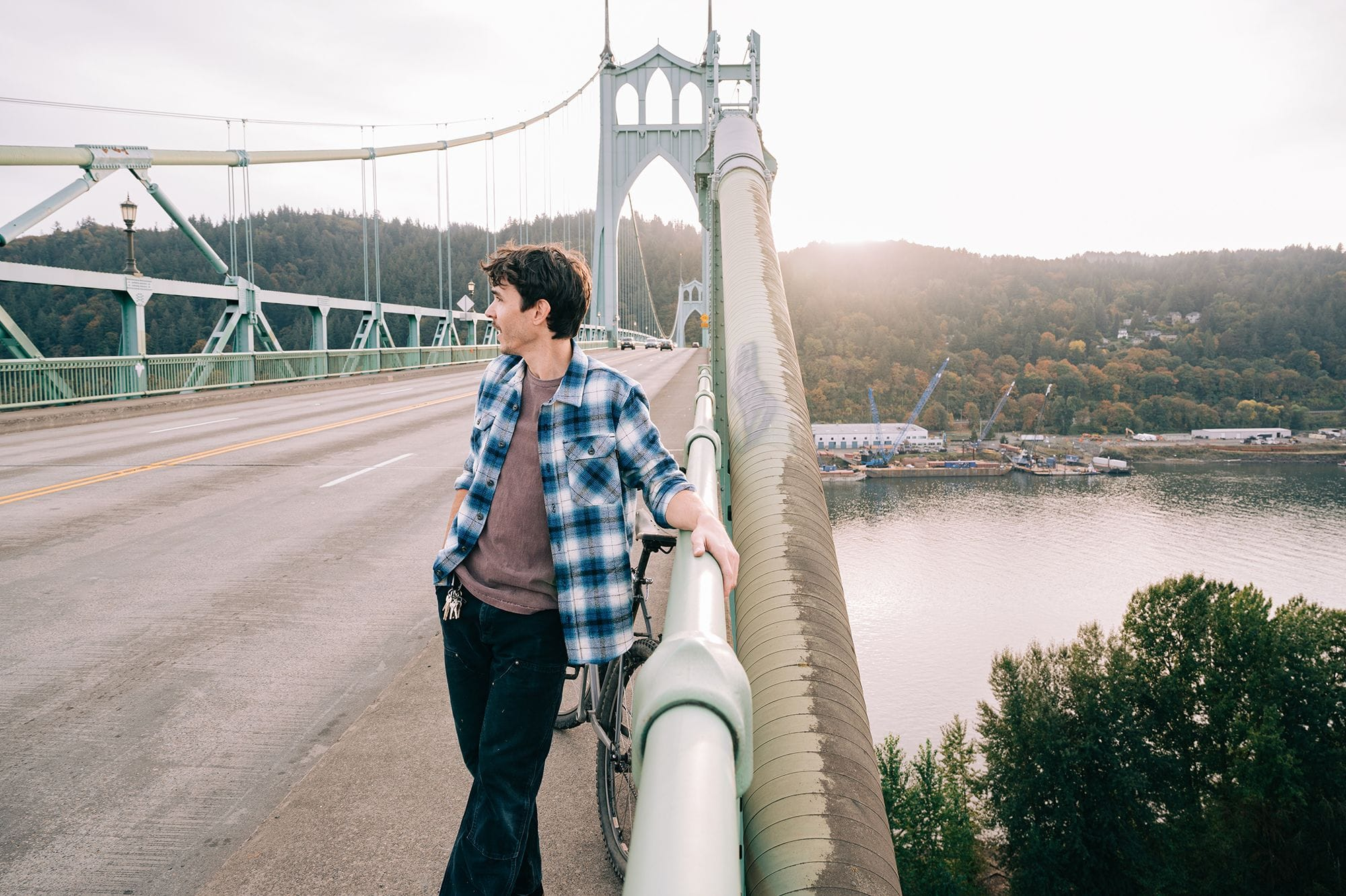 man on bridge in a devium flannel