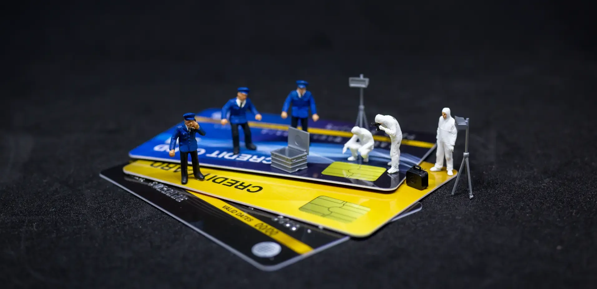 Miniatures of CSI/police on top of credit cards