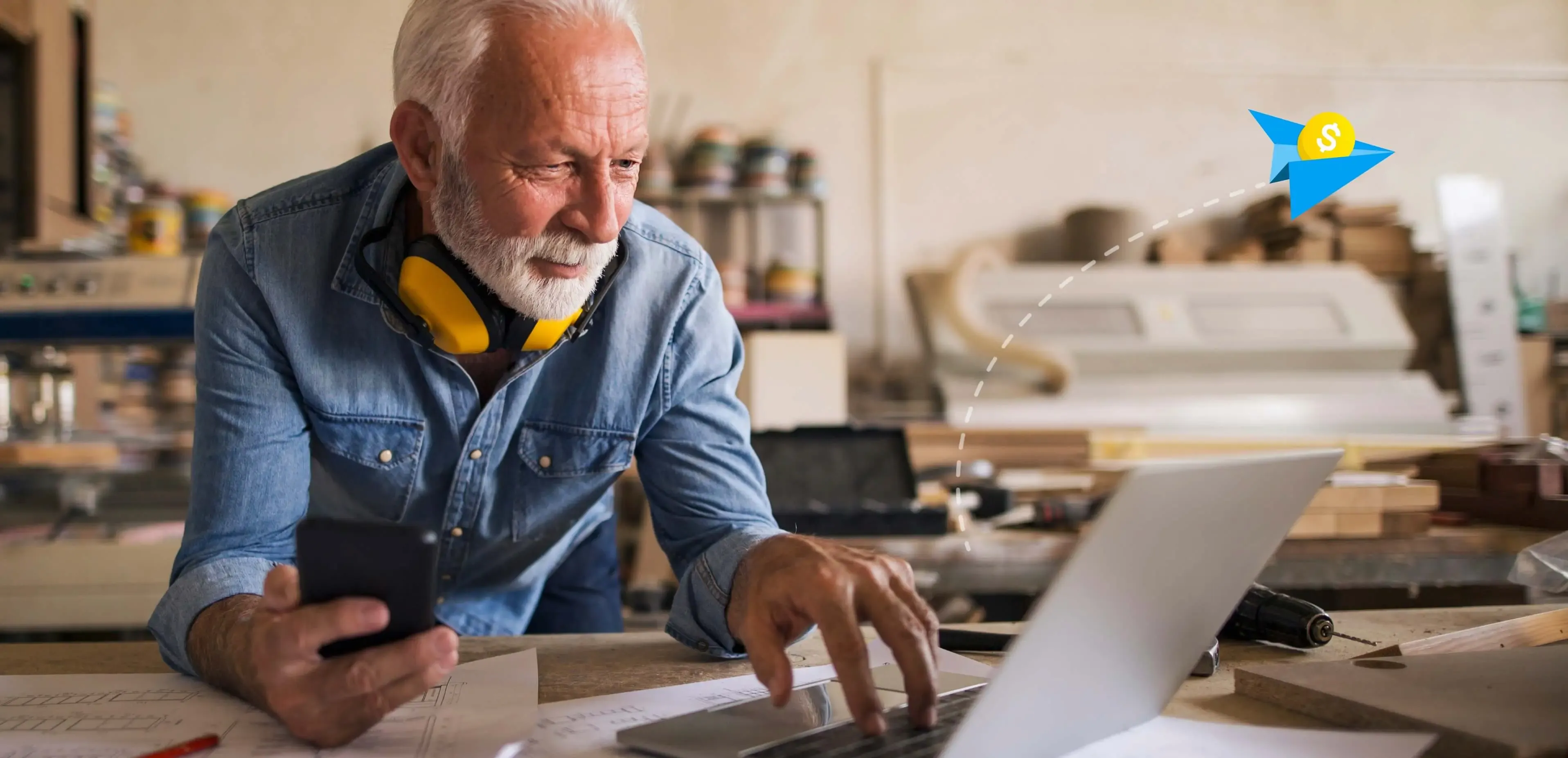 Man using computer as a paper airplane flies out of it