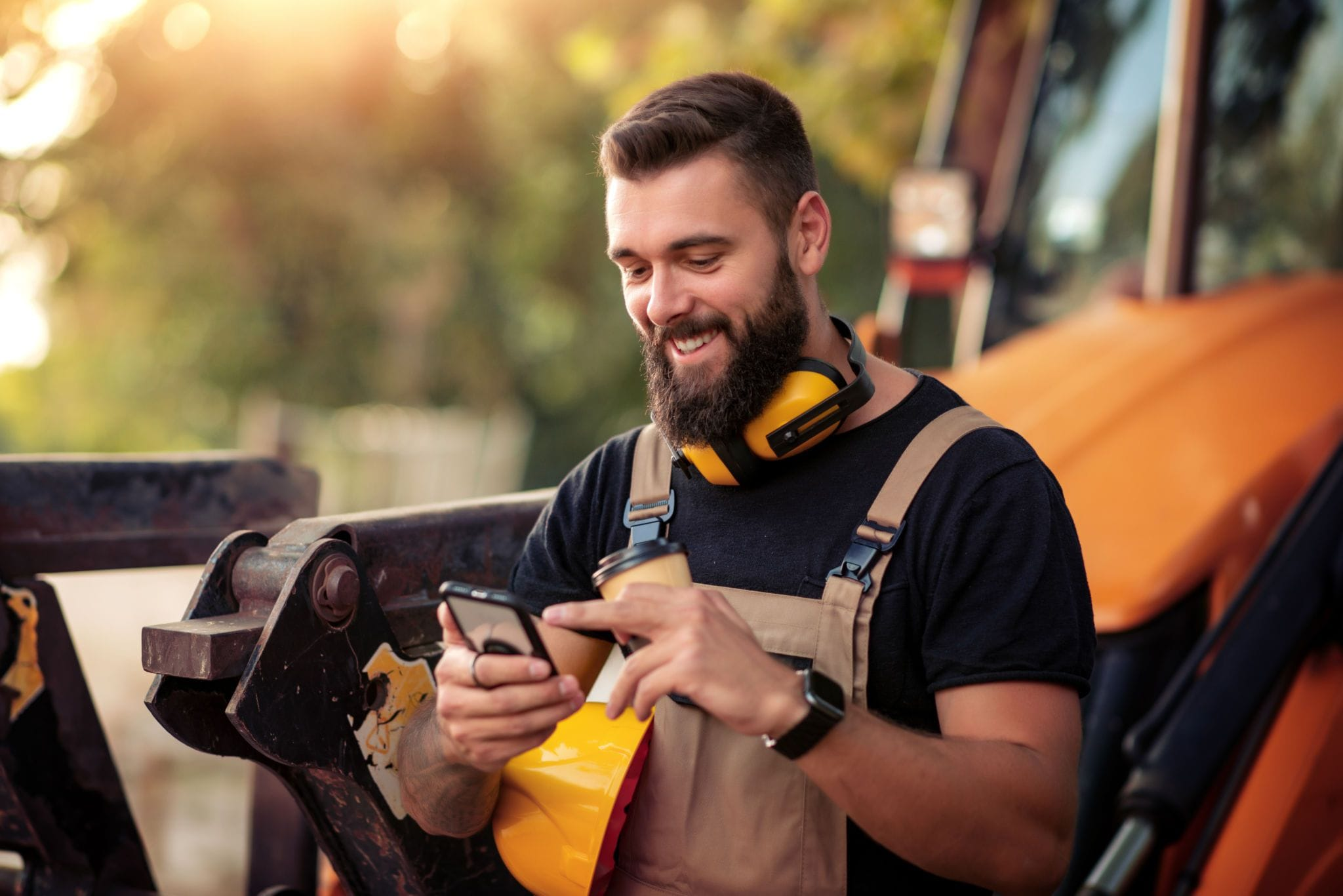 Contractor holding phone on construction site