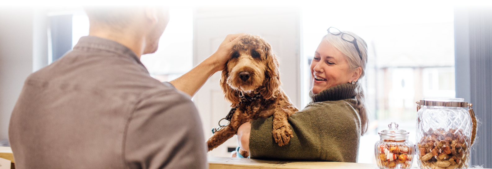 A woman and her dog assisted by MoeGo staff