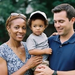 smiling woman with two children