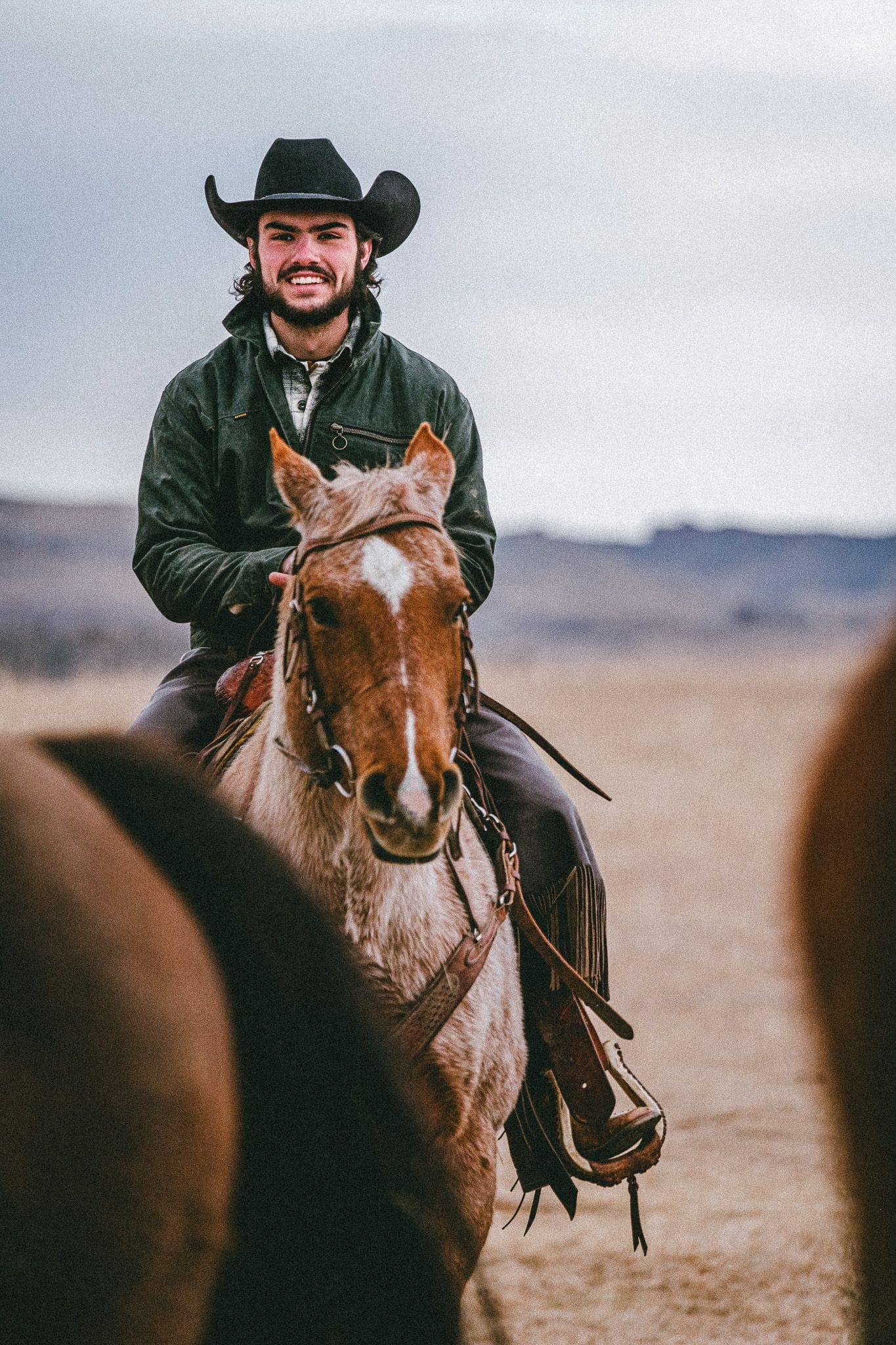 man in a cowboy hat wearing devium clothing