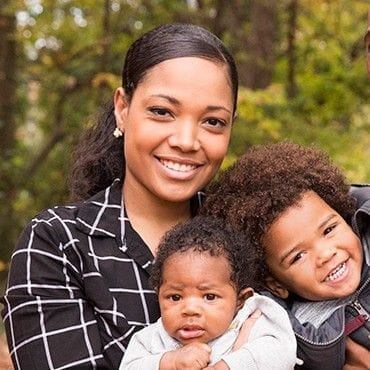 smiling woman with two children