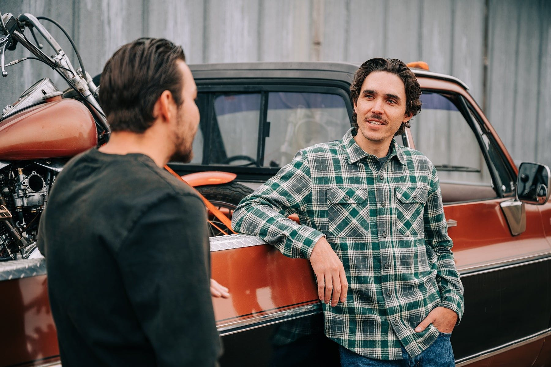 man wearing devium flannel in front of a truck