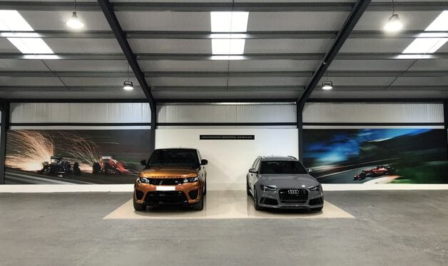 formula one wallpaper murals in a car showroom