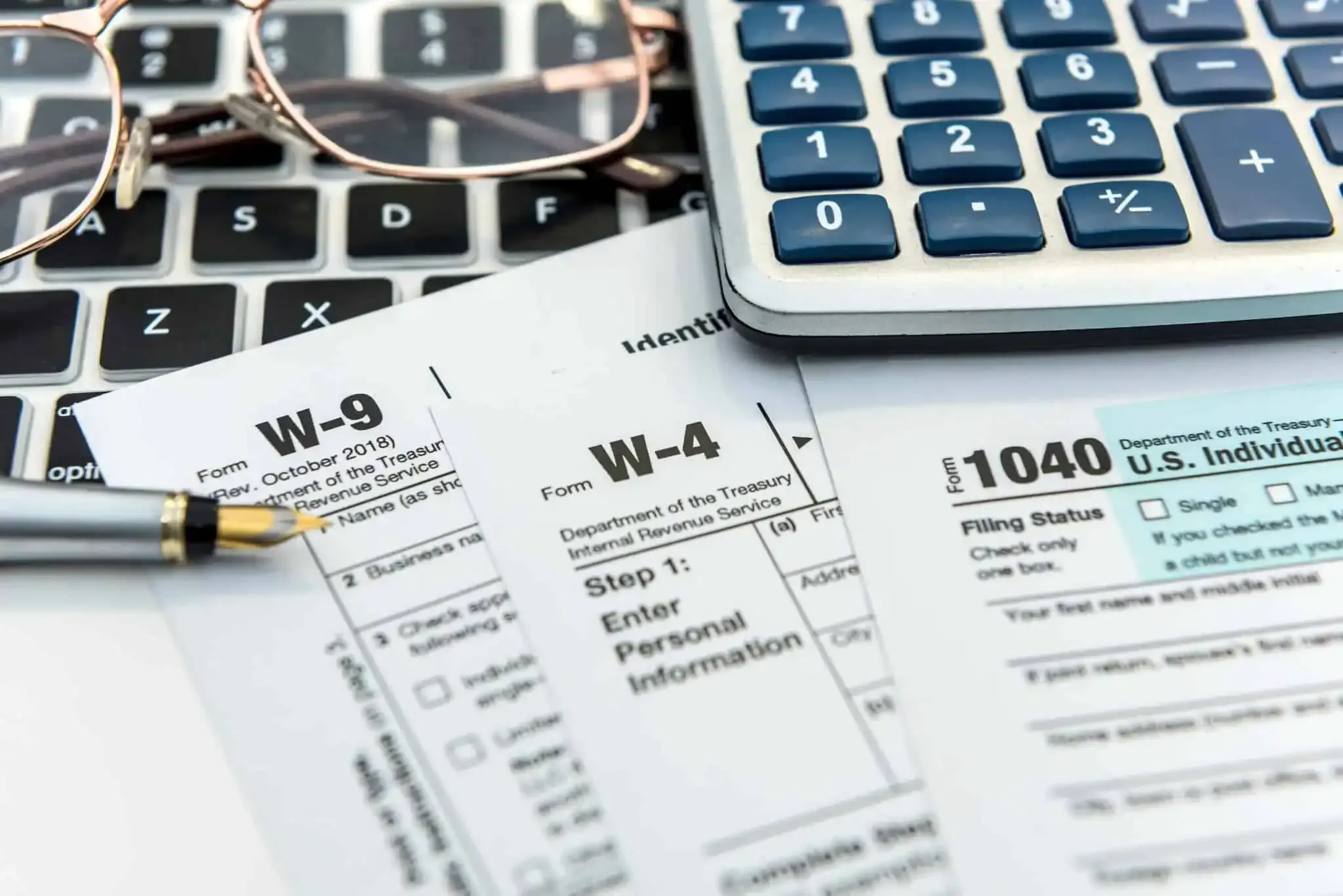Tax documents by a keyboard and calculator