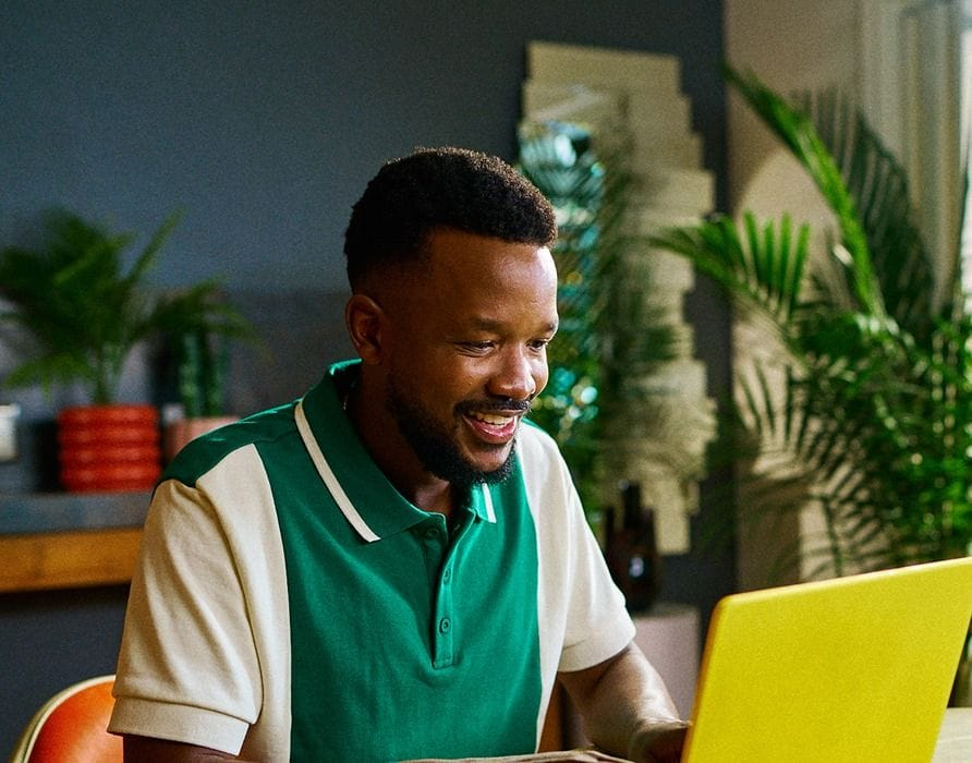 Happy employee working at their laptop