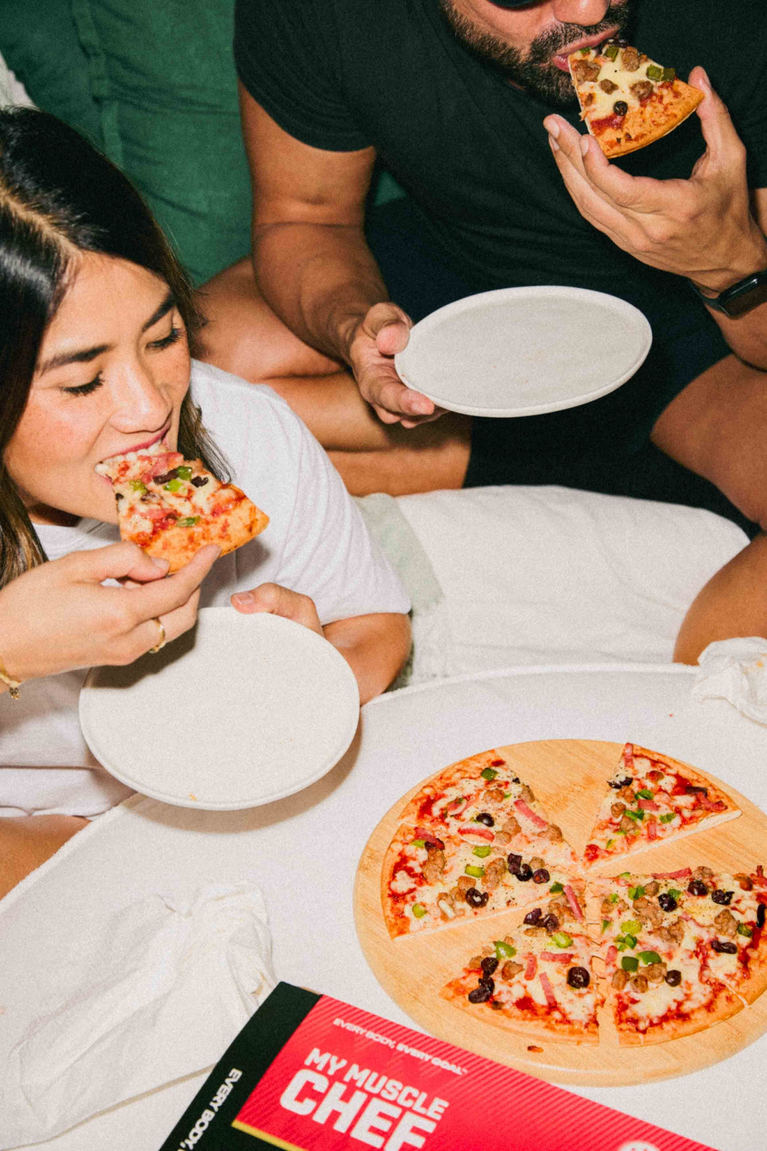 Girl eating a My Muscle Chef Protein Pizza