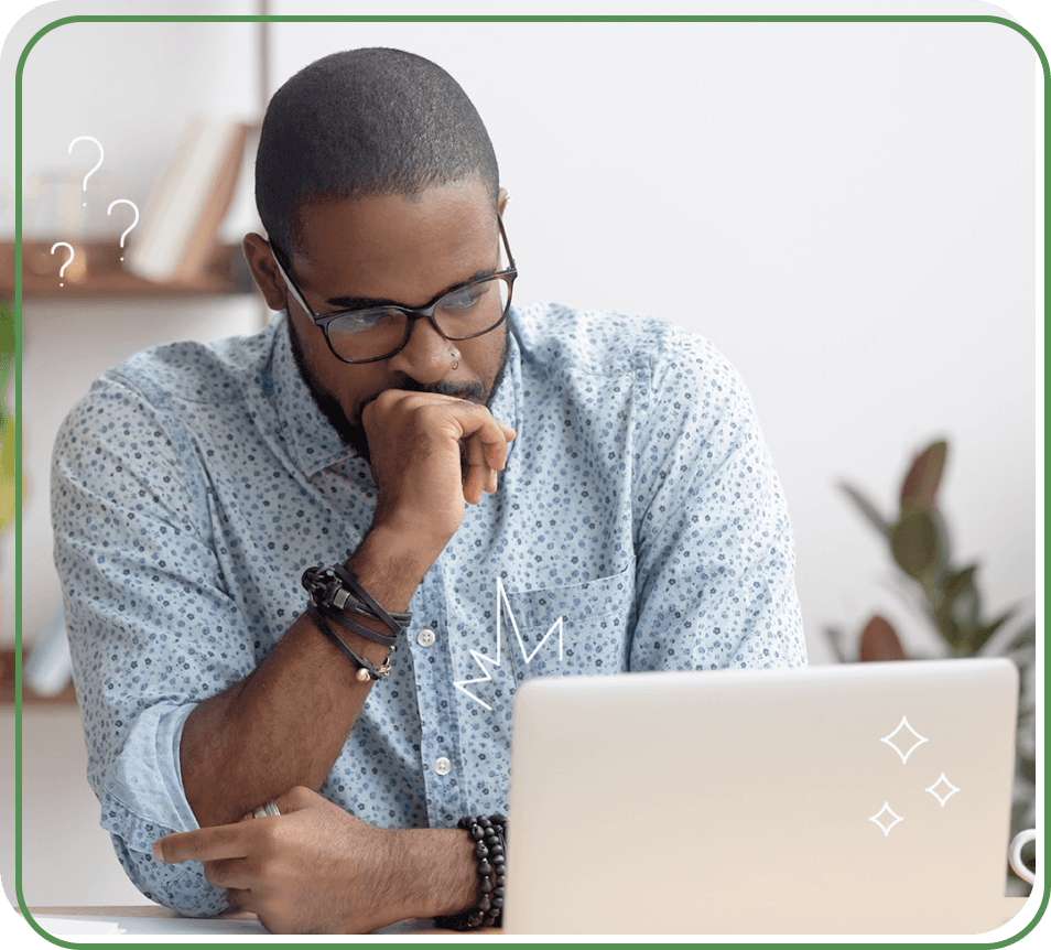 Photo of a thoughtful man reading information from a computer