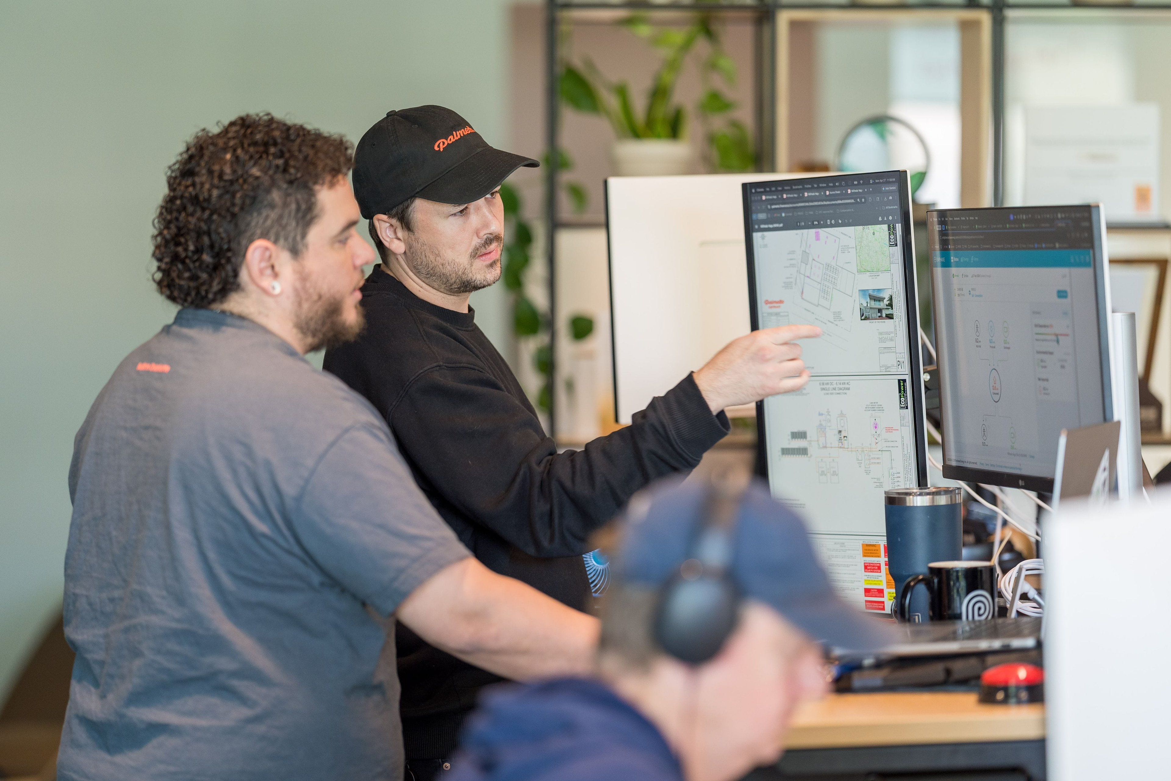 Two Palmetto employees collaborating on a computer in an office.