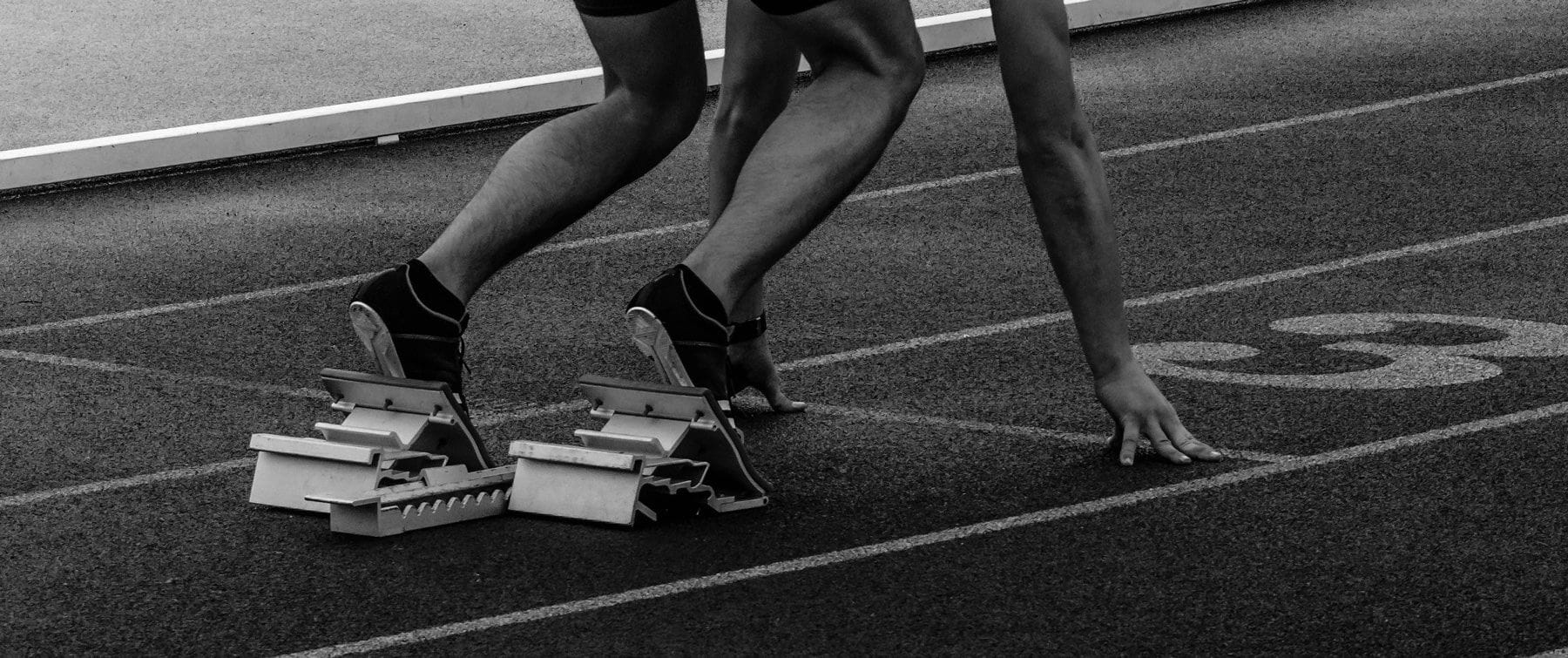 Athlete in starting blocks on a race track, with My Muscle Chef Pro meal featuring chicken and broccoli overlaid with 'Fuel Your Pro Fuel' text.