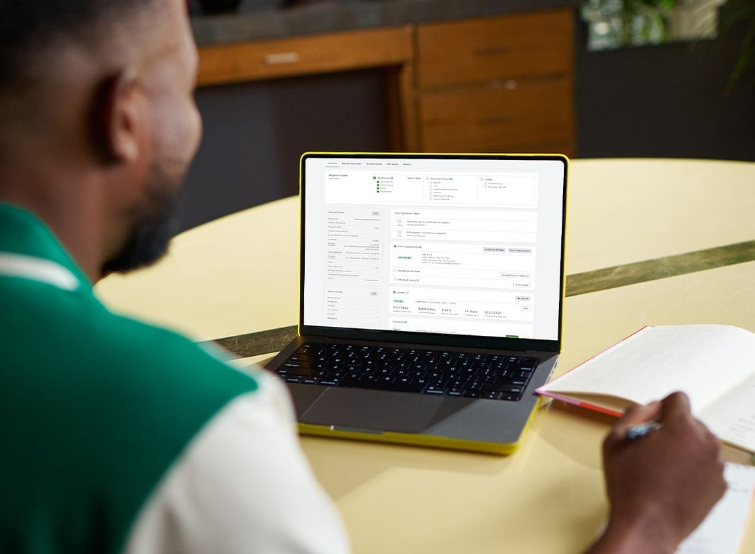 A person using the dealer portal on a laptop
