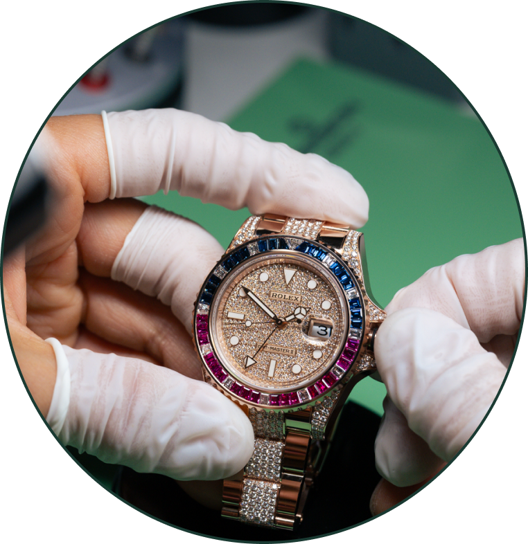 a pair of gloved hands holding a luxury watch