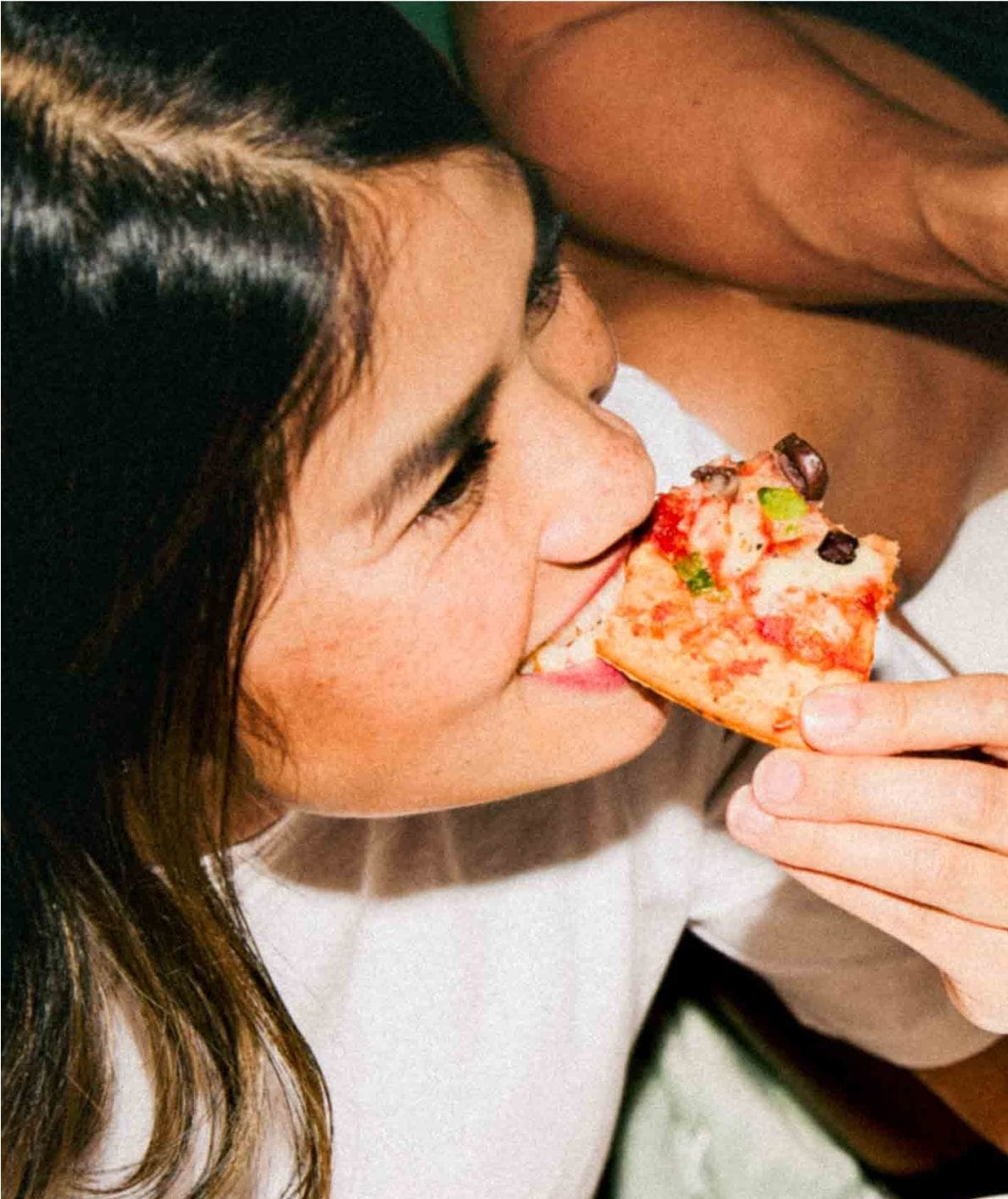 Girl eating a My Muscle Chef Protein Pizza