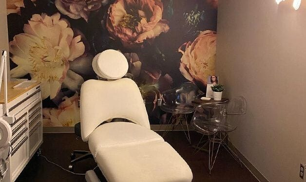 dark floral wall mural in a beauty treatment room