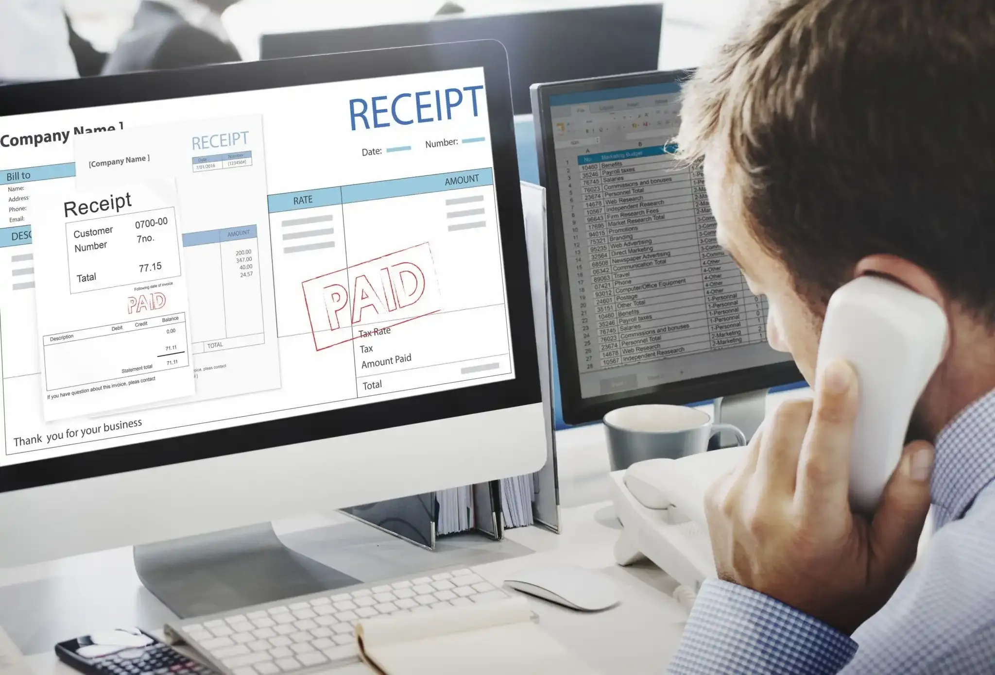 Businessman looking at paid receipt on computer screen
