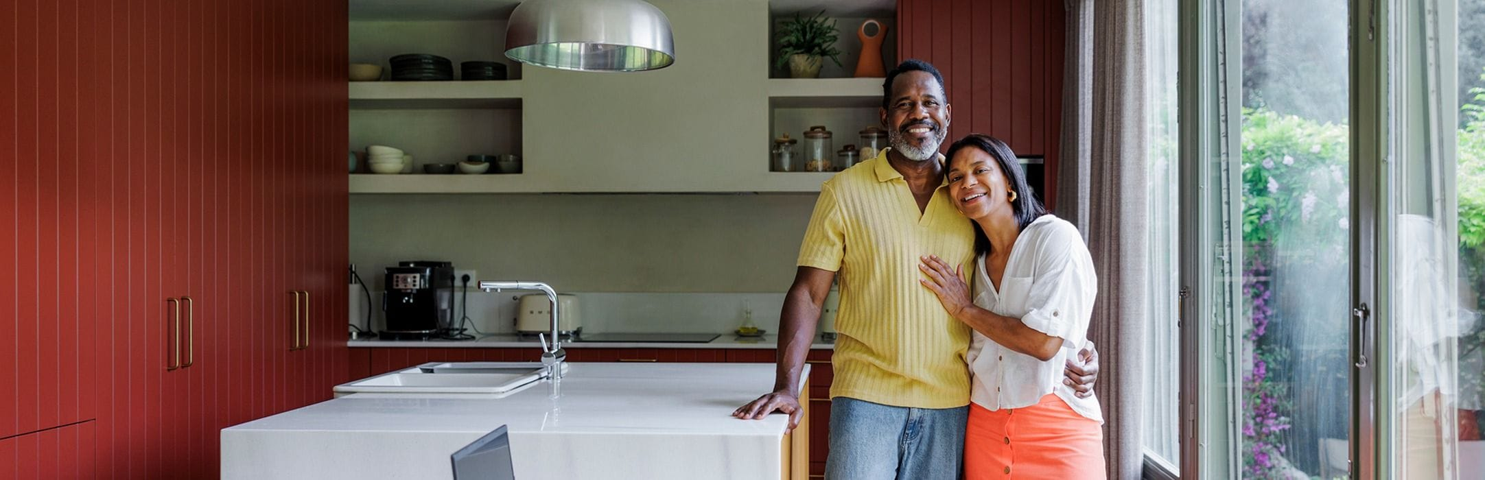 Family in their kitchen posing for a photograph