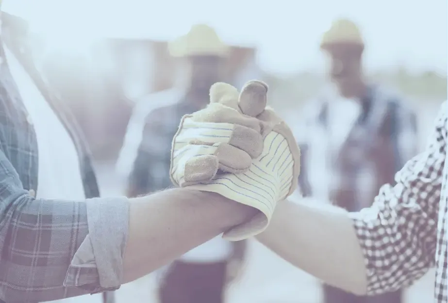 Construction workers clasping hands in solidarity