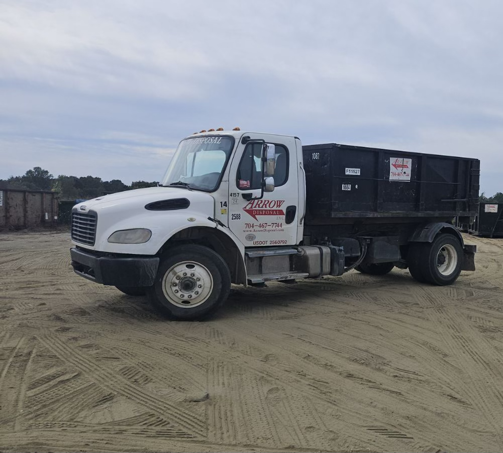 Arrow Disposal Truck on top of sand on construction site