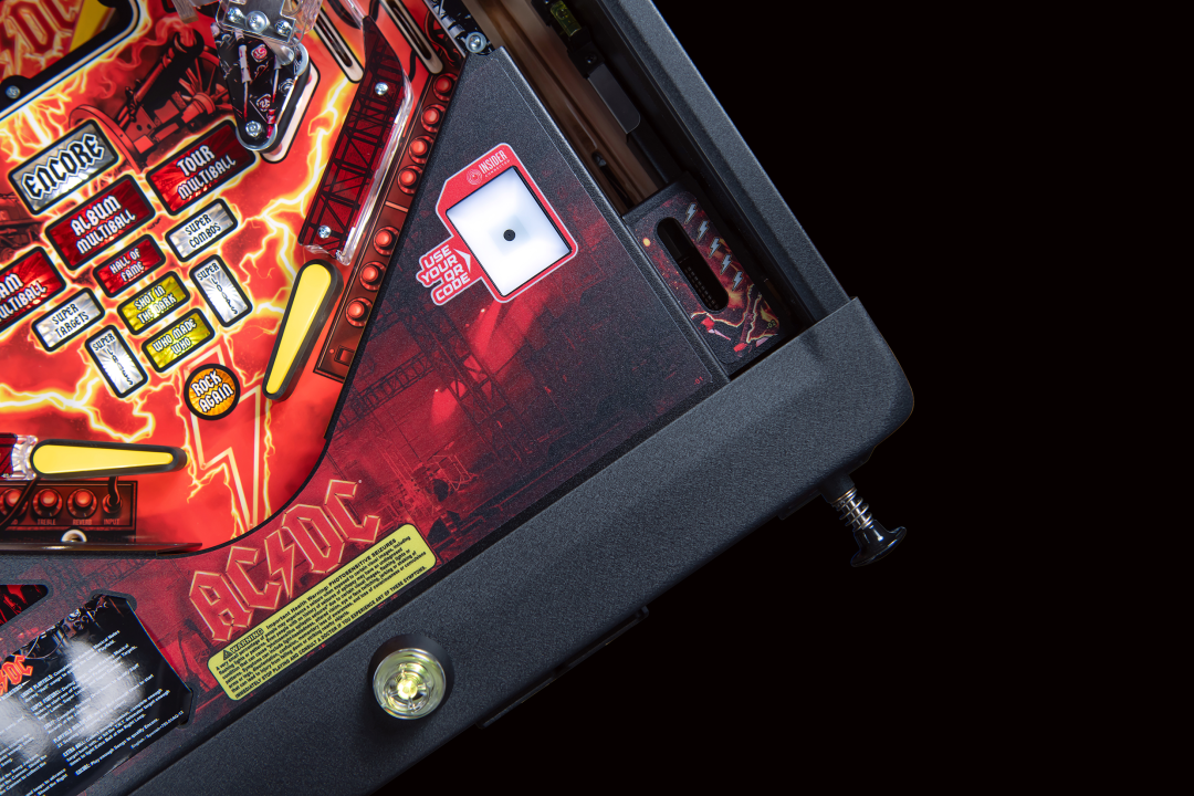 A lockdown bar with an action button illuminated yellow onA lower playfield with illuminated inserts on  the AC/DC Remastered pinball machine by Stern Pinball.