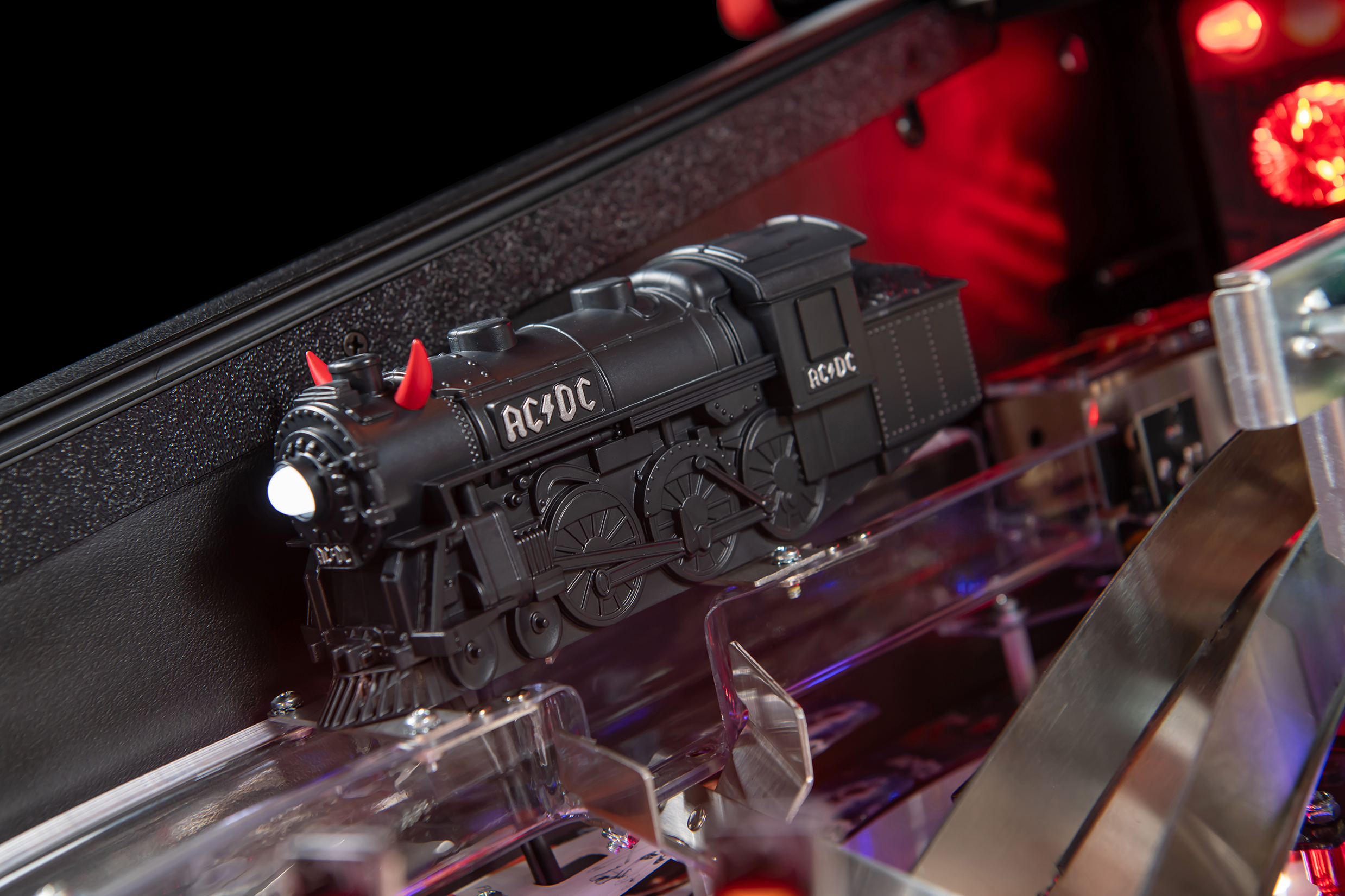 A custom sculpted train with red horns on the AC/DC Remastered pinball machine by Stern Pinball.