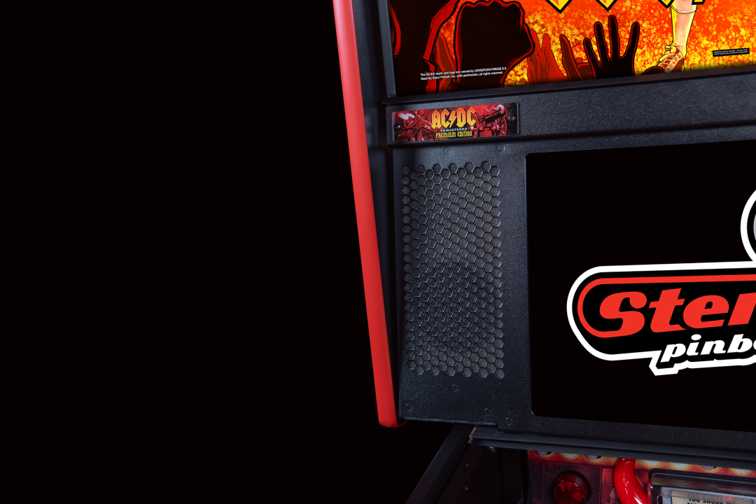 Speakers and an LCD screen on A lower playfield with illuminated inserts on the AC/DC Remastered pinball machine by Stern Pinball.