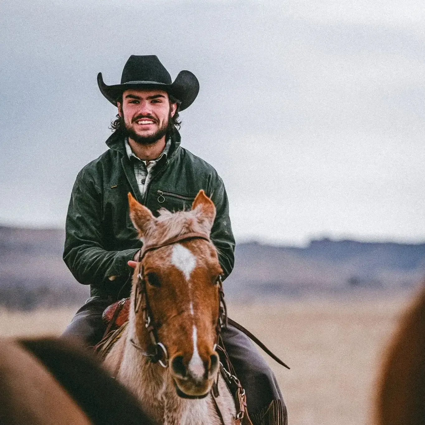 man in a cowboy hat wearing devium clothing