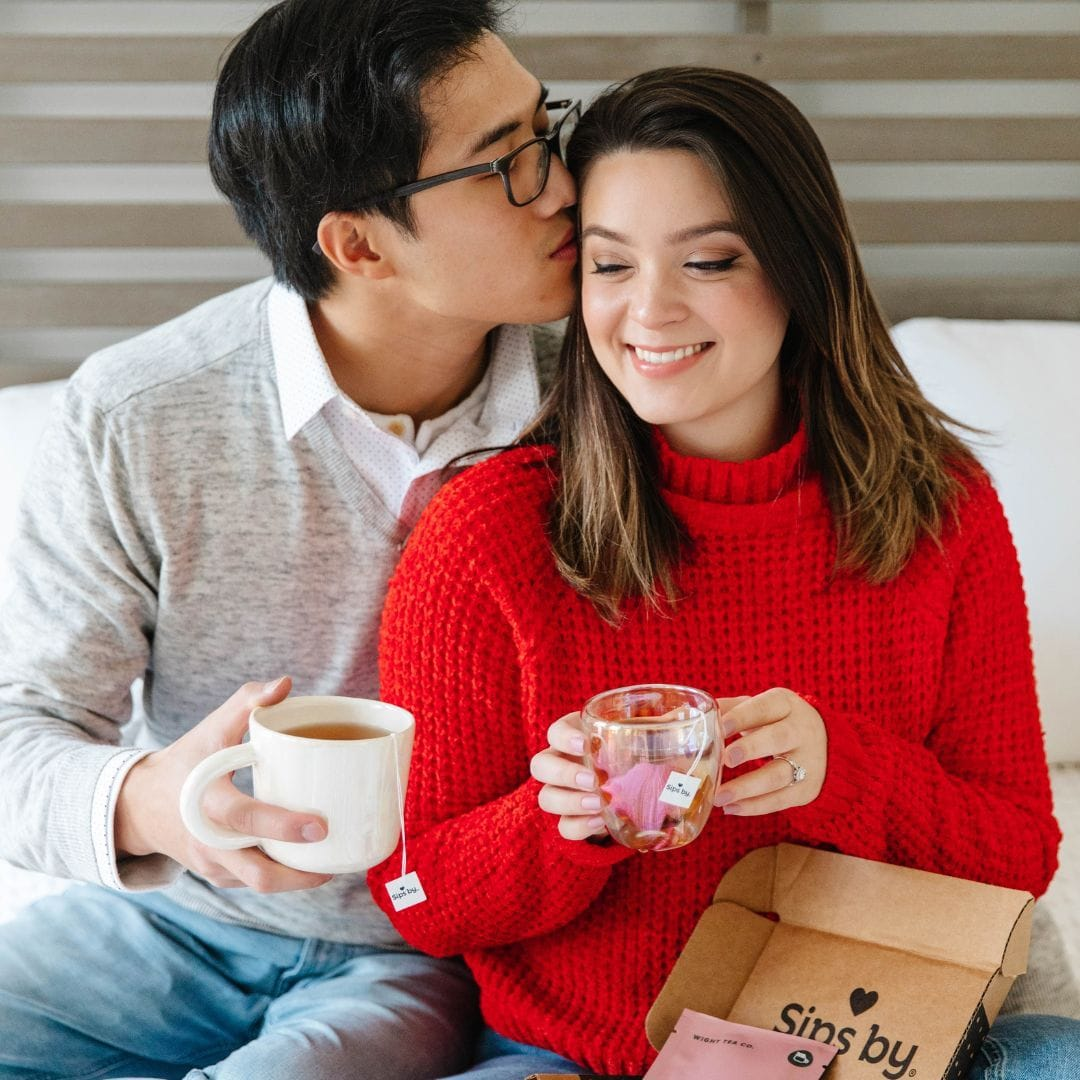 Couple holding mugs of Sips by Tea