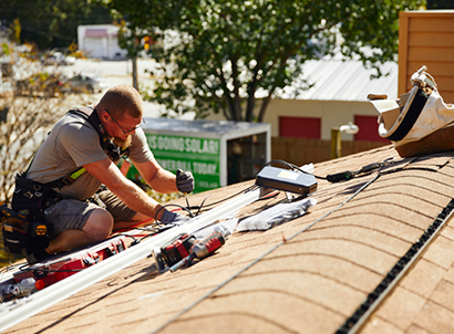 A solar installer on a roof