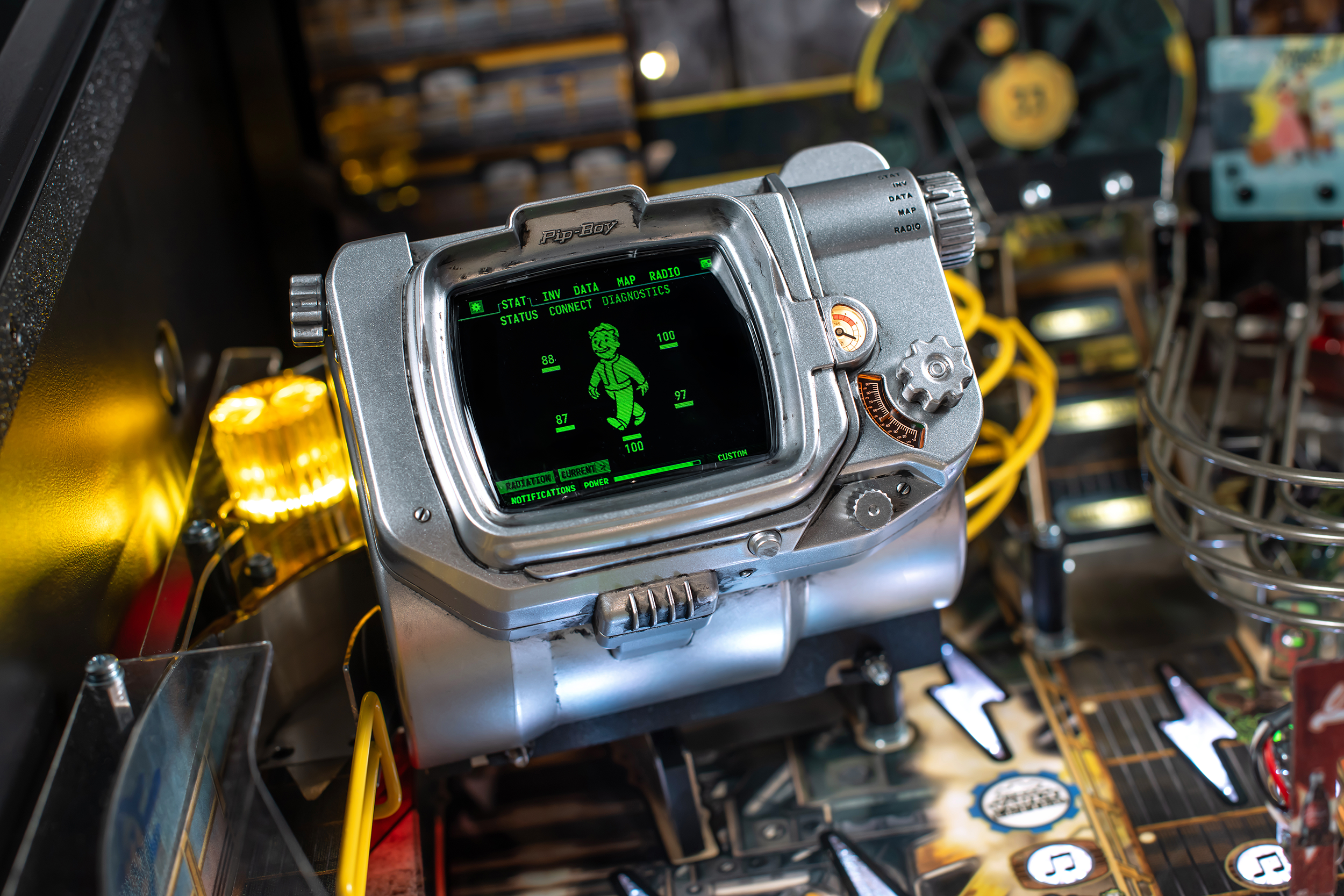 A Pipboy device with a live display on the playfield of the Pro Model of Fallout Pinball by Stern.