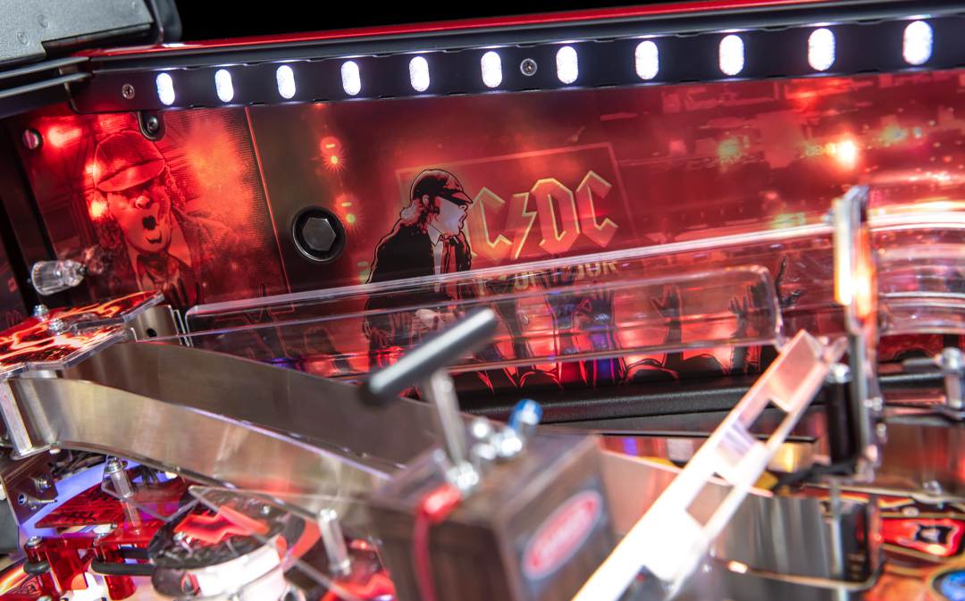 Custom artwork on inside of the cabinet with expression lighting above on the AC/DC Remastered pinball machine by Stern Pinball.