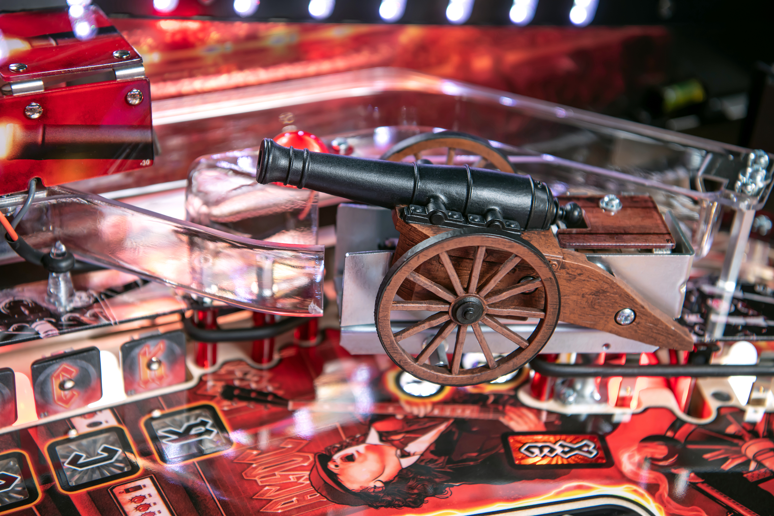A custom sculpted canon with a plastic ramp in the background on the AC/DC Remastered pinball machine by Stern Pinball.