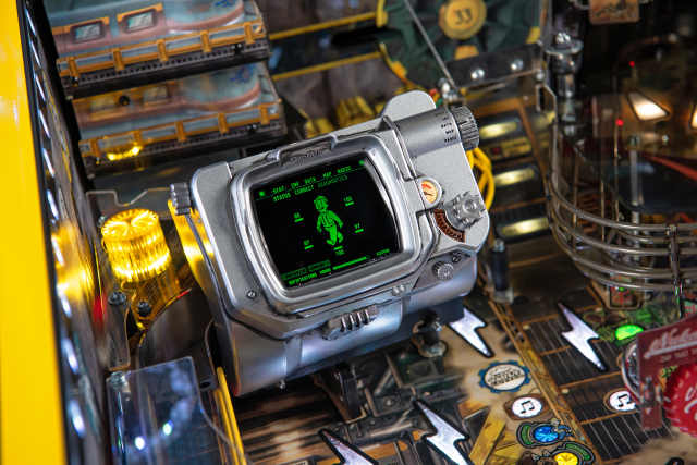 A Pipboy device with a live display on the playfield of the Fallout Pinball machine by Stern.